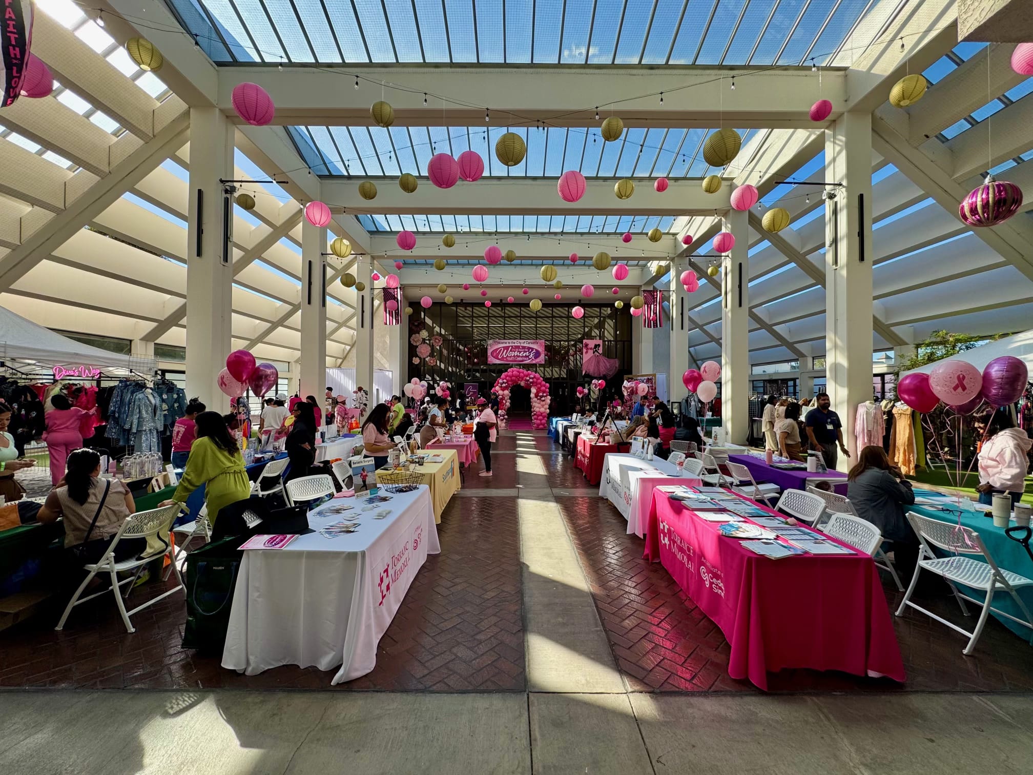 Wide view of the women’s health gathering and community tables