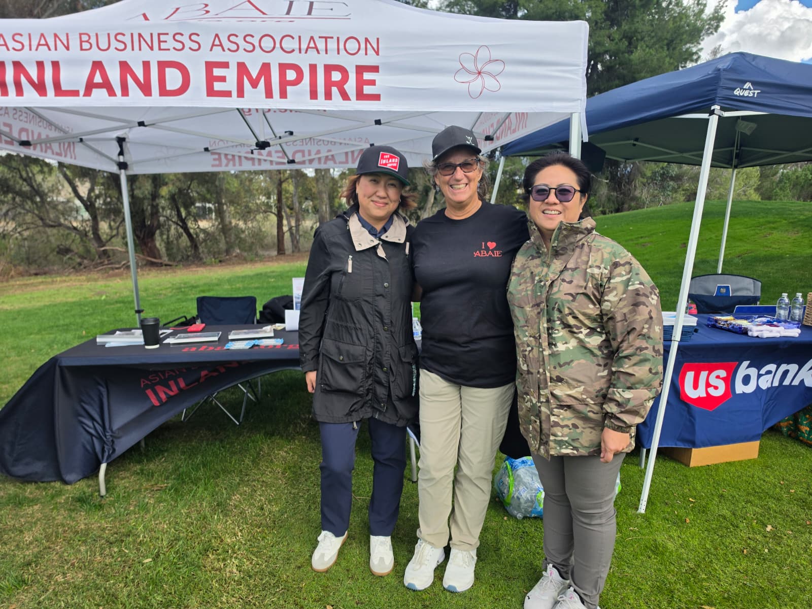 Three people together at the ABAIE community booth